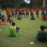 
              Coaches speak to youths during a break of a soccer training session at the Pedro Marrero stadium in Havana, Cuba, Wednesday, Sept. 14, 2022. These coaches also will be responsible for training more than 1,500 other coaches across the island in upcoming months. (AP Photo/Ramon Espinosa)
            