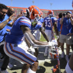 
              Florida wide receiver Caleb Douglas (12) celebrates with a drum major mace on the sideline after scoring a touchdown during the second half of an NCAA college football game against Eastern Washington, Sunday, Oct. 2, 2022, in Gainesville, Fla. (AP Photo/Phelan M. Ebenhack)
            