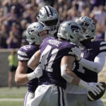 
              Kansas State linebacker Austin Moore (41) celebrates with teammates after intercepting a pass during the first half of an NCAA college football game against Texas Tech Saturday, Oct. 1, 2022, in Manhattan, Kan. (AP Photo/Charlie Riedel)
            