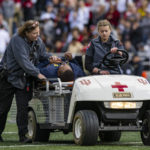 
              Michigan running game coordinator Mike Hart was carted off the field on a backboard during the first half of an NCAA college football game against Indiana, Saturday, Oct. 8, 2022, in Bloomington, Ind. (AP Photo/Doug McSchooler)
            