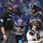 
              Atlanta Braves' Dansby Swanson, right, reacts to a call by home plate umpire Manny Gonzalez (79) during the eighth inning of a baseball game against the Miami Marlins, Monday, Oct. 3, 2022, in Miami. (AP Photo/Wilfredo Lee)
            