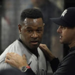 
              New York Yankees starting pitcher Luis Severino, left, listens to manager Aaron Boone in the dugout after the seventh inning of a baseball game against the Texas Rangers in Arlington, Texas, Monday, Oct. 3, 2022. (AP Photo/LM Otero)
            