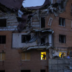 
              People check the damage at their apartments hit by a Russian missile in Mykolaiv, Ukraine, Sunday, Oct. 23, 2022. (AP Photo/Emilio Morenatti)
            