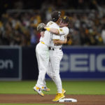 
              San Diego Padres second baseman Jake Cronenworth, right, celebrates with teammate shortstop Ha-Seong Kim after the Padres defeated the Los Angeles Dodgers 2-1 in Game 3 of a baseball NL Division Series, Friday, Oct. 14, 2022, in San Diego. (AP Photo/Ashley Landis)
            