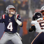 
              New England Patriots quarterback Bailey Zappe (4) throws while pressured by Chicago Bears defensive end Al-Quadin Muhammad (55) during the second half of an NFL football game, Monday, Oct. 24, 2022, in Foxborough, Mass. (AP Photo/Michael Dwyer)
            