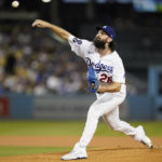 
              Los Angeles Dodgers starting pitcher Tony Gonsolin (26) throws during the first inning of a baseball game against the Colorado Rockies in Los Angeles, Monday, Oct. 3, 2022. (AP Photo/Ashley Landis)
            