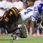 
              Kentucky running back Chris Rodriguez Jr. (24) dives for yardage as he is tackled by Tennessee defensive lineman Roman Harrison (30) during the first half of an NCAA college football game Saturday, Oct. 29, 2022, in Knoxville, Tenn. (AP Photo/Wade Payne)
            
