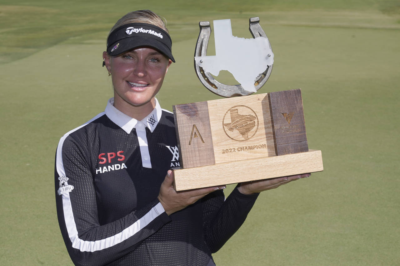 Charley Hull, of England, poses with the champion's trophy after winning the LPGA The Ascendant gol...