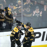 
              Boston Bruins left wing Jake DeBrusk (74) is congratulated by Patrice Bergeron after his goal against Florida Panthers goaltender Sergei Bobrovsky during the first periood of an NHL hockey game, Monday, Oct. 17, 2022, in Boston. (AP Photo/Charles Krupa)
            