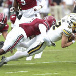 
              Missouri quarterback Brady Cook (12) is tackled by South Carolina defensive back Devonni Reed (3) during the first half of an NCAA college football game on Saturday, Oct. 29, 2022, in Columbia, S.C. (AP Photo/Artie Walker Jr.)
            