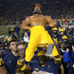 
              Michigan's Mike Sainristil carries the Paul Bunyan Trophy after an NCAA college football game against the Michigan State in Ann Arbor, Mich., Saturday, Oct. 29, 2022. Michigan won 29-7. (AP Photo/Paul Sancya)
            