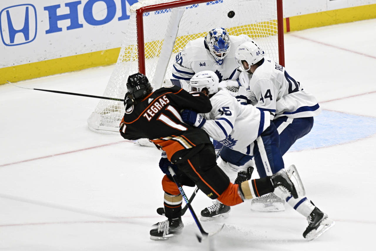 Anaheim Ducks center Trevor Zegras (11) scores on a shot past Toronto Maple Leafs goaltender Erik K...