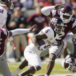 
              Texas A&M running back Devon Achane (6) runs for short yardage while being pursued by Mississippi State defenders during the first half of an NCAA college football game in Starkville, Miss., Saturday, Oct. 1, 2022. (AP Photo/Rogelio V. Solis)
            