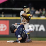 
              Seattle Mariners' Brian O'Keefe is forced out at second as Oakland Athletics second baseman Jordan Diaz throw to first to complete a couple play during during the fifth inning of a baseball game, Saturday, Oct. 1, 2022, in Seattle. (AP Photo/John Froschauer)
            