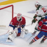 
              Minnesota Wild's Brandon Duhaime (21) scores on Montreal Canadiens goaltender Jake Allen as Canadiens' Jake Evans defends during the second period of an NHL hockey game, Tuesday, Oct. 25, 2022 in Montreal. (Graham Hughes/The Canadian Press via AP)
            