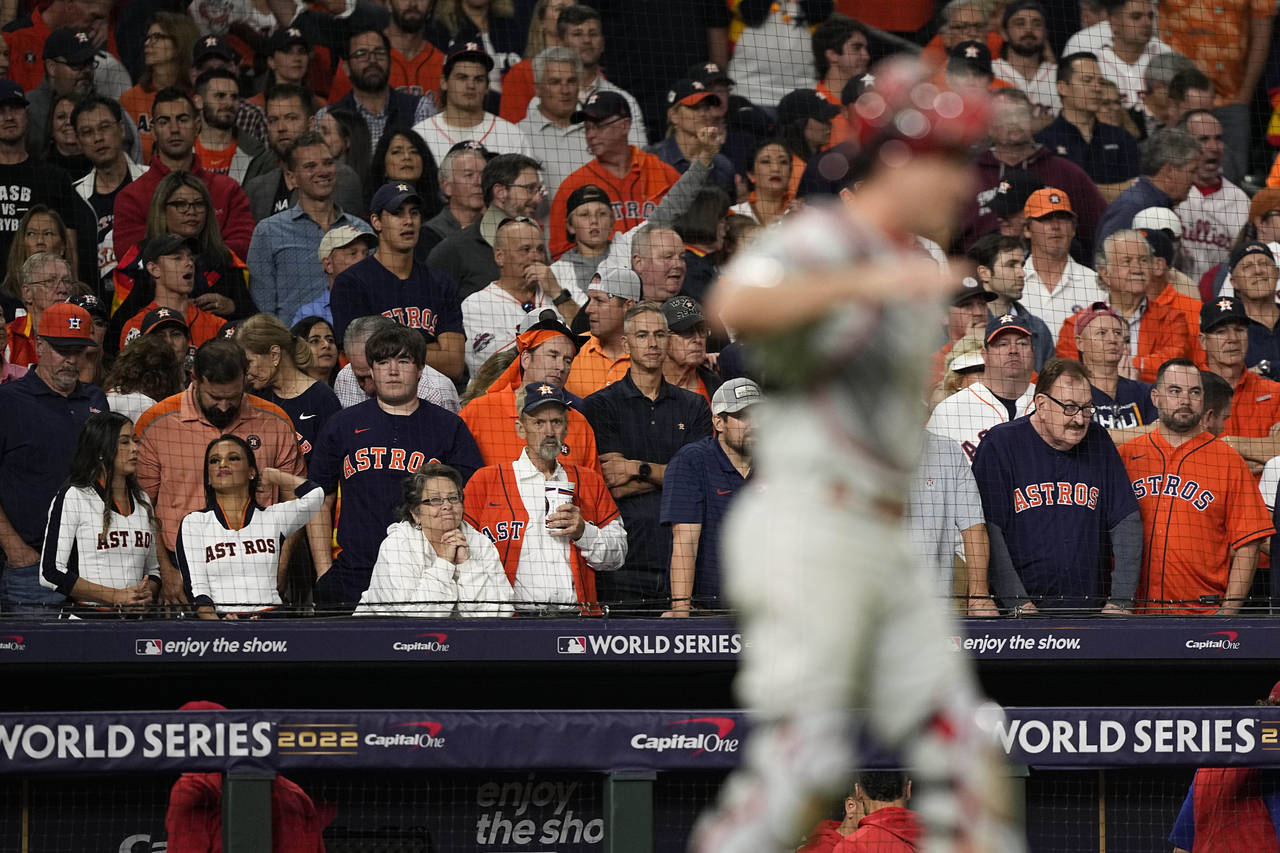 Houston Astros fans watch as the Philadelphia Phillies celebrate their win in Game 1 of baseball's ...