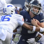 
              Utah State quarterback Cooper Legas (5) gets tackled by Air Force safety Jayden Goodwin (16) during the first half of an NCAA college football game Saturday, Oct. 8, 2022, in Logan, Utah. (Eli Lucero/The Herald Journal via AP)
            