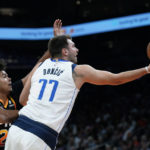 
              Dallas Mavericks guard Luka Doncic (77) drives past Phoenix Suns forward Cameron Johnson to score during the first half of an NBA basketball game in Phoenix, Wednesday, Oct. 19, 2022. (AP Photo/Ross D. Franklin)
            