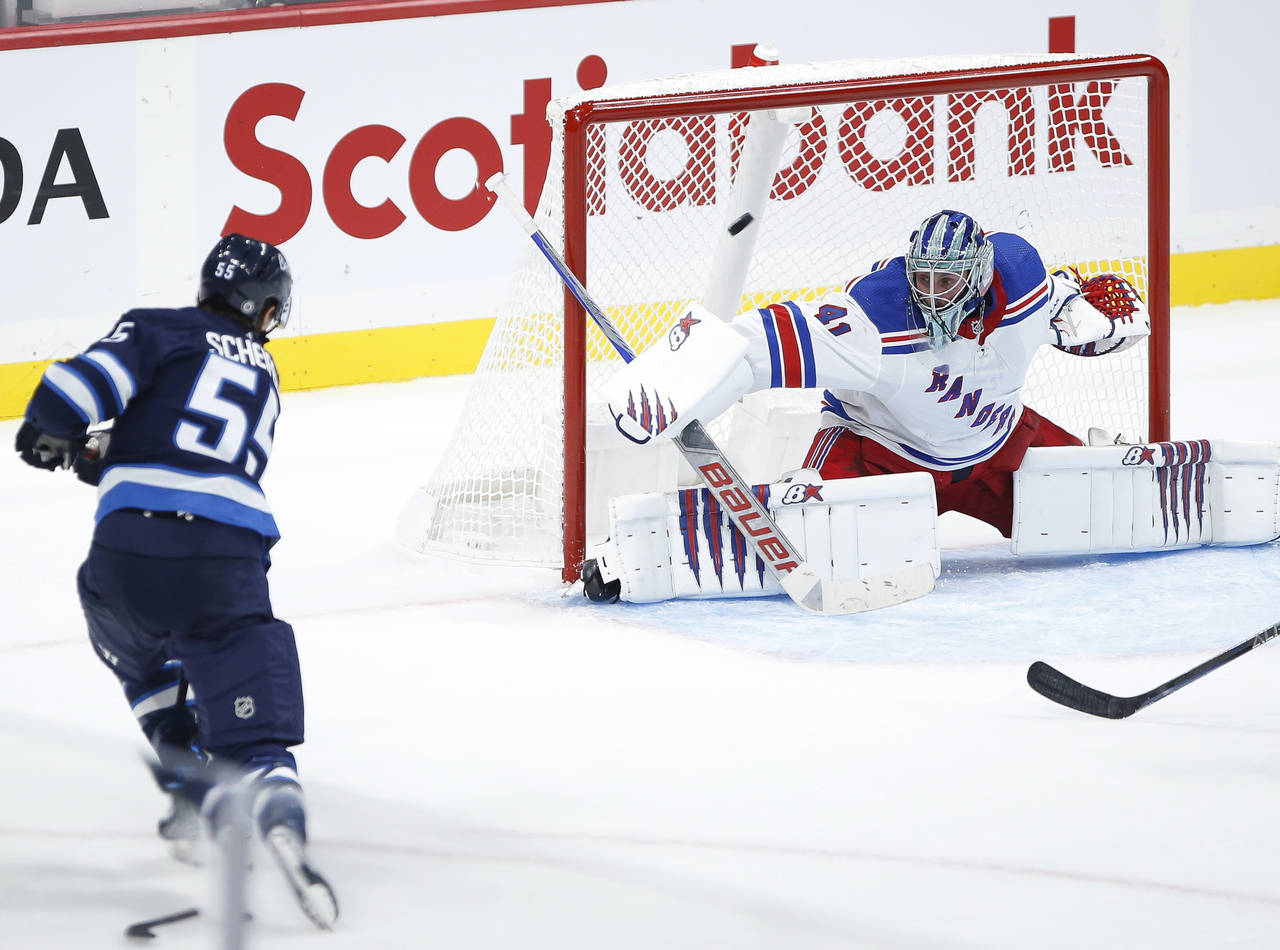 Winnipeg Jets' Mark Scheifele (55) scores against New York Rangers goaltender Jaroslav Halak (41) d...