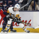 
              Pittsburgh Penguins forward Danton Heinen, right, reaches for the puck in front of Columbus Blue Jackets defenseman Vladislav Gavrikov during the second period of an NHL hockey game in Columbus, Ohio, Saturday, Oct. 22, 2022. (AP Photo/Paul Vernon)
            