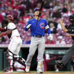 
              Chicago Cubs' Seiya Suzuki, center, reacts after being called out on strikes during the first inning of the team's baseball game against the Cincinnati Reds on Tuesday, Oct. 4, 2022, in Cincinnati. (AP Photo/Jeff Dean)
            