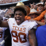 
              Texas defensive lineman Byron Murphy II (90) celebrates with the golden hat after an NCAA college football game against Oklahoma at the Cotton Bowl in Dallas, Saturday, Oct. 8, 2022. Texas won 49-0. (AP Photo/LM Otero)
            