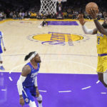
              Los Angeles Lakers forward LeBron James, right, shoots as Los Angeles Clippers forward Robert Covington defends during the first half of an NBA basketball game Thursday, Oct. 20, 2022, in Los Angeles. (AP Photo/Mark J. Terrill)
            