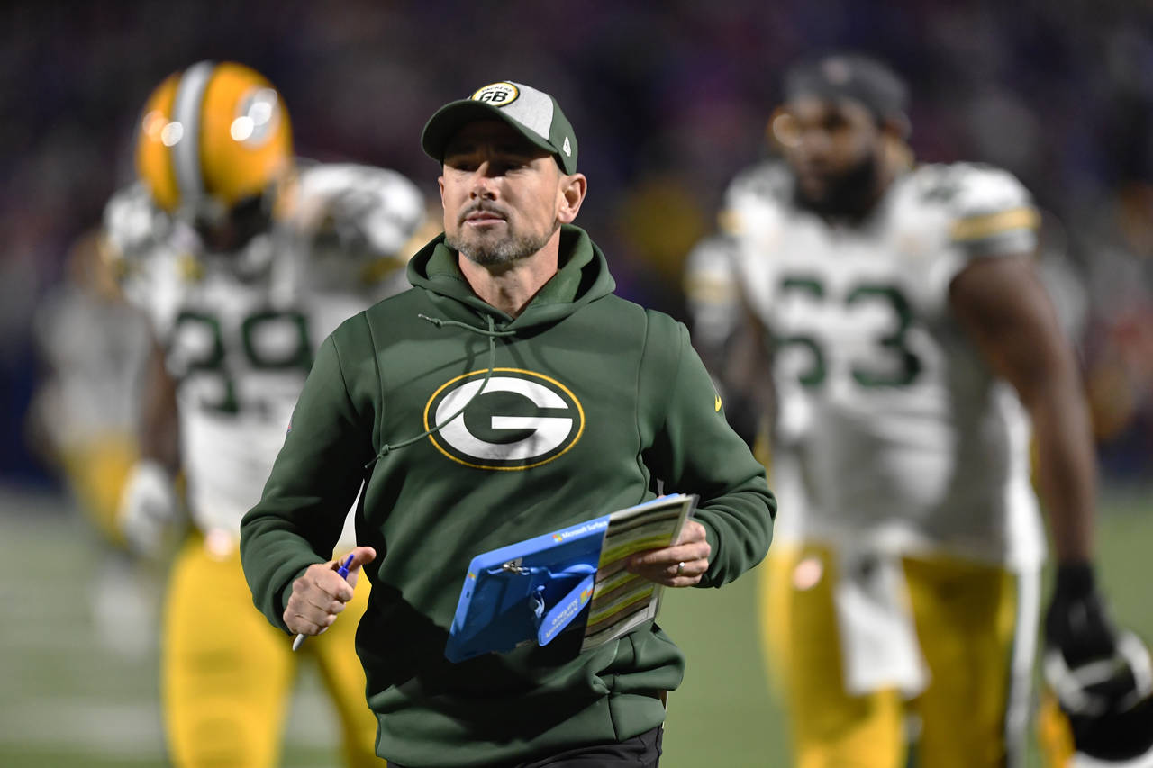 Green Bay Packers head coach Matt LaFleur runs to the locker room at the halftime during an NFL foo...