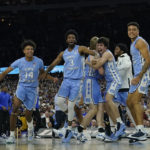 
              FILE - North Carolina players celebrate their victory against Duke after a college basketball game in the semifinal round of the Men's Final Four NCAA tournament, Saturday, April 2, 2022, in New Orleans. North Carolina won 81-77. With four starters back from the team that blew a 15-point halftime lead to Kansas at the Superdome in New Orleans, the Tar Heels were the runaway pick as the preseason No. 1 in the AP Top 25 on Monday, Oct. 17, 2022. (AP Photo/David J. Phillip, File)
            
