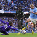 
              Southampton goalkeeper Gavin Bazunu saves at the feet of Manchester City's Erling Haaland during the English Premier League soccer match between Manchester City and Southampton at Etihad stadium in Manchester, England, Saturday, Oct. 8, 2022. (Martin Rickett/PA via AP)
            