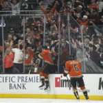 
              Anaheim Ducks right wing Troy Terry (19) jumps against the glass after scoring during the first period of the team's NHL hockey game against Seattle Kraken in Anaheim, Calif., Wednesday, Oct. 12, 2022. (AP Photo/Kyusung Gong)
            