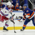 
              New York Rangers defenseman Jacob Trouba (8) looks to pass against New York Islanders center Kyle Palmieri (21) in the second period of an NHL hockey game, Wednesday, Oct. 26, 2022, in Elmont, N.Y. (AP Photo/John Minchillo)
            