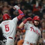 
              Philadelphia Phillies' Bryson Stott (5) celebrates with Kyle Schwarber after hitting a home run against the Houston Astros during the eighth inning of a baseball game Monday, Oct. 3, 2022, in Houston. (AP Photo/David J. Phillip)
            