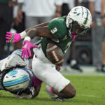 
              South Florida running back Kelley Joiner (3) can't hang onto a pass after getting hit by Tulane linebacker Dorian Williams (2) during the second half of an NCAA college football game Saturday, Oct. 15, 2022, in Tampa, Fla. (AP Photo/Chris O'Meara)
            