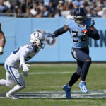 
              Tennessee Titans running back Derrick Henry (22) runs with the ball as Indianapolis Colts safety Rodney Thomas II (25) defends during the first half of an NFL football game Sunday, Oct. 23, 2022, in Nashville, Tenn. (AP Photo/Mark Zaleski)
            
