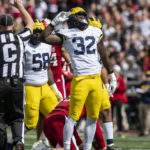 
              Michigan linebacker Jaylen Harrell (32) reacts after sacking Indiana quarterback Connor Bazelak (9) during the first half of an NCAA college football game, Saturday, Oct. 8, 2022, in Bloomington, Ind. (AP Photo/Doug McSchooler)
            