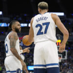 
              Minnesota Timberwolves guard D'Angelo Russell, left, and center Rudy Gobert talk during the first half of the team's NBA basketball game against the Oklahoma City Thunder, Wednesday, Oct. 19, 2022, in Minneapolis. (AP Photo/Abbie Parr)
            