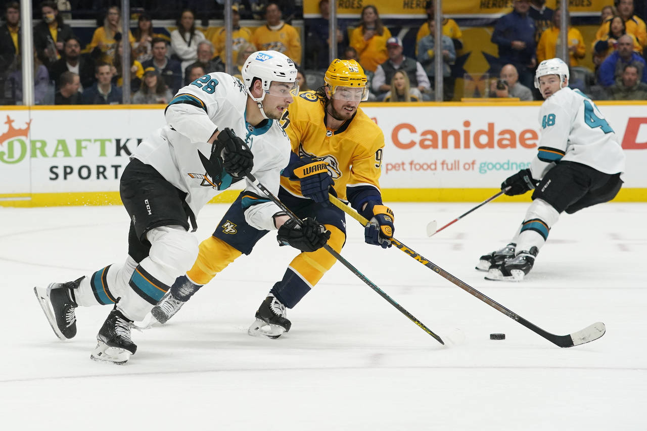 FILE - San Jose Sharks' Timo Meier (28) and Nashville Predators' Matt Duchene (95) chase the puck i...