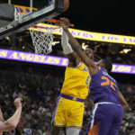 
              Los Angeles Lakers forward LeBron James (6) blocks a shot by Phoenix Suns forward Mikal Bridges (25) during the first half of a preseason NBA basketball game Wednesday, Oct. 5, 2022, in Las Vegas. (AP Photo/John Locher)
            