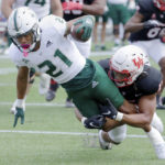 
              South Florida running back Brian Battie (21) dives for the end zone to score as Houston linebacker Mannie Nunnery, right, tackles during the first half of an NCAA college football game Saturday, Oct. 29, 2022, in Houston. (AP Photo/Michael Wyke)
            