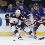 
              Columbus Blue Jackets left wing Gustav Nyquist (14) plays the puck against New York Rangers defenseman Adam Fox (23) during the first period of an NHL hockey game, Sunday, Oct. 23, 2022, in New York. (AP Photo/Noah K. Murray)
            