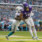 
              Minnesota Vikings wide receiver Adam Thielen (19) scores a touchdown under pressure from Miami Dolphins cornerback Xavien Howard (25), during the second half of an NFL football game, Sunday, Oct. 16, 2022, in Miami Gardens, Fla. (AP Photo/Lynne Sladky)
            