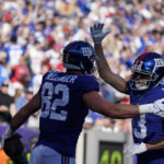 
              New York Giants' David Sills V (13) celebrates with teammate Daniel Bellinger (82) after Bellinger scored a touchdown during the second half of an NFL football game against the Baltimore Ravens, Sunday, Oct. 16, 2022, in East Rutherford, N.J. (AP Photo/John Minchillo)
            