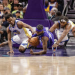 
              Golden State Warriors forward Andrew Wiggins and Charlotte Hornets forward Jalen McDaniels dive for a loose ball during the first half of an NBA basketball game on Saturday, Oct. 29, 2022, in Charlotte, N.C. (AP Photo/Scott Kinser)
            