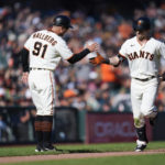 
              San Francisco Giants' Mike Yastrzemski, right, celebrates with third base coach Mark Hallberg (91) after hitting a solo home run against the Arizona Diamondbacks during the eighth inning of a baseball game in San Francisco, Saturday, Oct. 1, 2022. (AP Photo/Godofredo A. Vásquez)
            