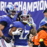 
              New York Giants' Wan'Dale Robinson (17) celebrates with teammate Saquon Barkley (26) after scoring a touchdown during the first half of an NFL football game against the Baltimore Ravens, Sunday, Oct. 16, 2022, in East Rutherford, N.J. (AP Photo/John Minchillo)
            
