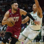 
              Boston Celtics forward Grant Williams (12) defends Miami Heat guard Max Strus (31) during the first half of an NBA game Friday, Oct. 21, 2022, in Miami. (AP Photo/Marta Lavandier)
            