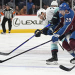 
              Seattle Kraken right wing Jordan Eberle, left, shoots as Colorado Avalanche center Nathan MacKinnon defends during the second period of an NHL hockey game Friday, Oct. 21, 2022, in Denver. (AP Photo/David Zalubowski)
            