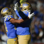 
              UCLA running back Zach Charbonnet (24) and offensive lineman Raiqwon O'Neal (71) celebrate after scoring a touchdown during the first half of an NCAA college football against Stanford game in Pasadena, Calif., Saturday, Oct. 29, 2022. (AP Photo/Ashley Landis)
            