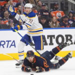 
              Buffalo Sabres' Tage Thompson (72) trips Edmonton Oilers' Darnell Nurse (25) during the first period of an NHL hockey game Tuesday, Oct. 18, 2022, in Edmonton, Alberta. (Jason Franson/The Canadian Press via AP)
            